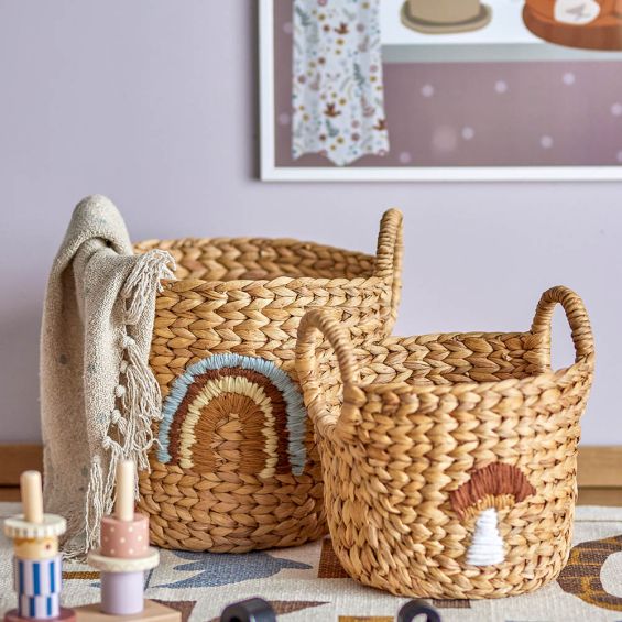 Two woven baskets with rainbow and mushroom
