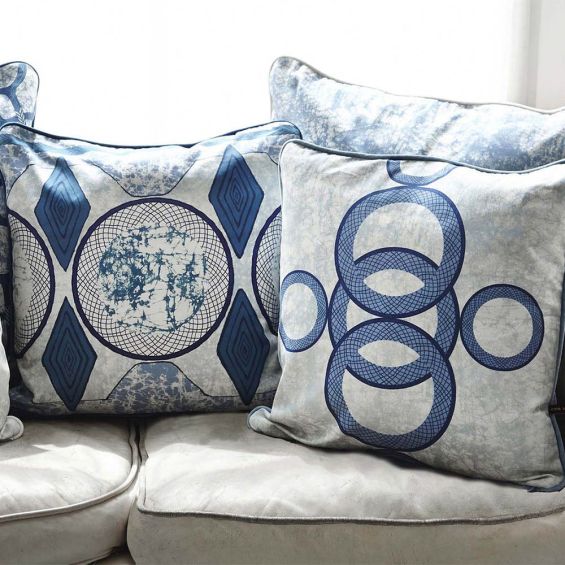 A luxury cushion by Eva Sonaike with a blue African-inspired pattern