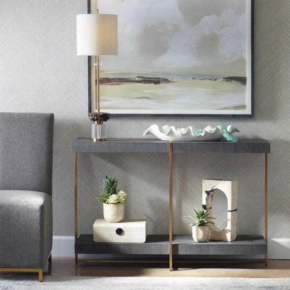 Modern grey console table with sleek stainless steel frame adorned in brushed brass