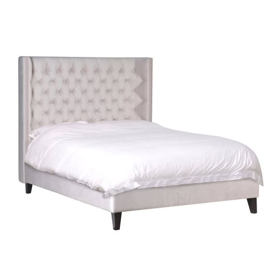 Luxurious beige velvet double bed with deep buttoned headboard