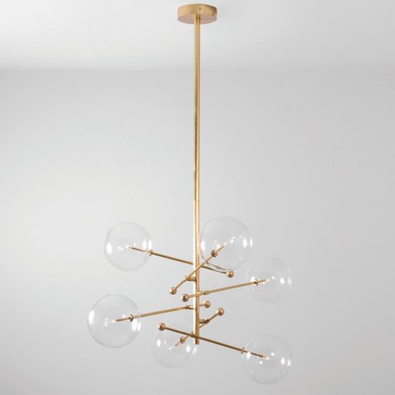 Industrial style 6 arm chandelier in a natural brass finish with 6 clear glass globe bulbs