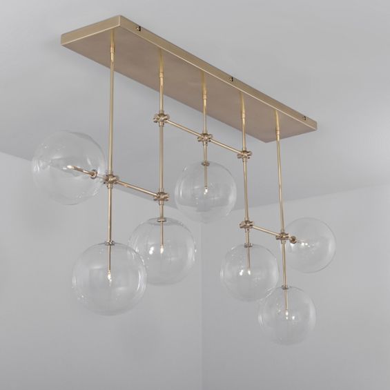 Natural brass finish industrial style chandelier with hanging clear glass globes