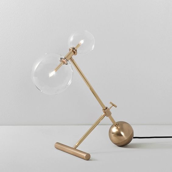 Industrial style table lamp in a natural brass finish with clear glass lampshade design