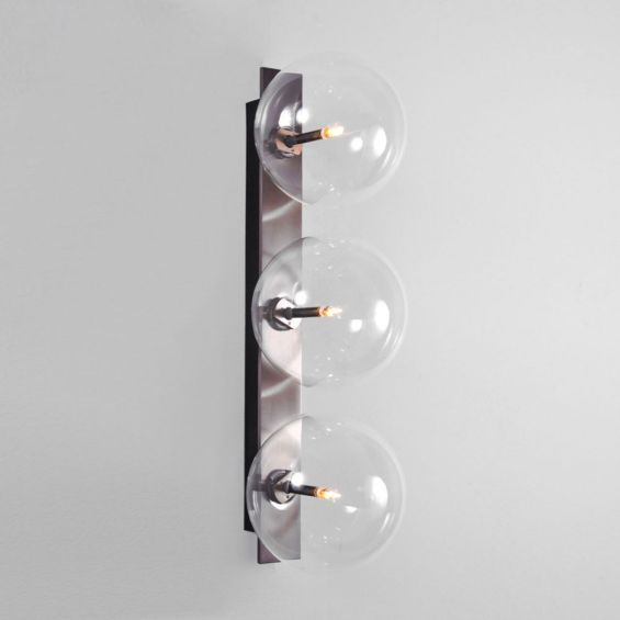 A glamorous industrial-style triple light wall lamp in a black gunmetal finish