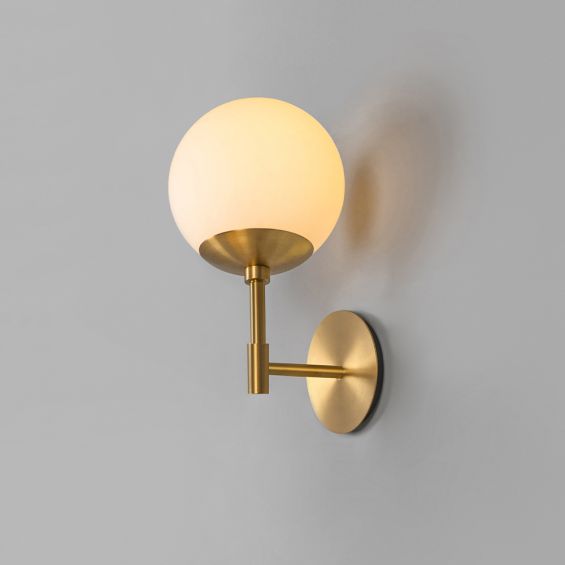 A glamorous wall lamp by Schwung with a spherical glass shade and beautiful brass base