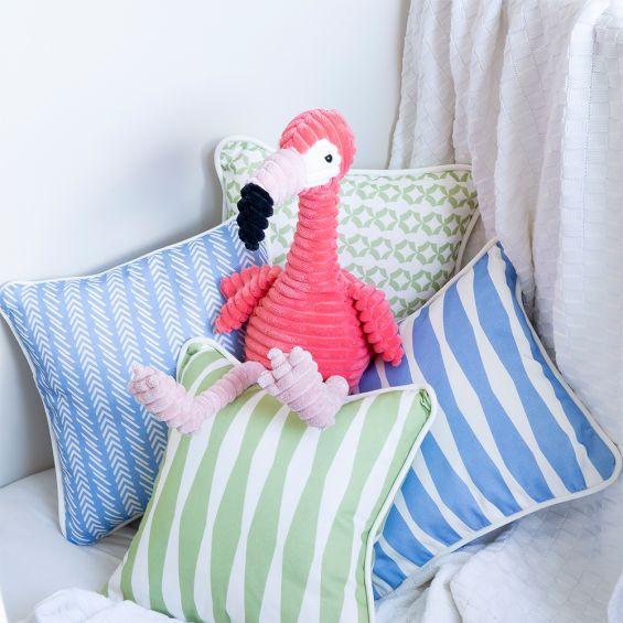 A gorgeous green children's cushion with a striped design and white piping