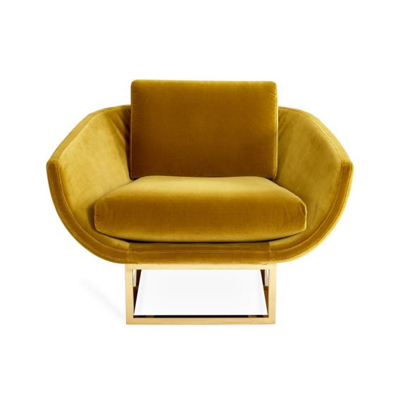 A luxurious golden-yellow velvet-upholstered lounge chair with a brushed brass base