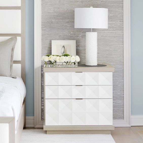 A unique three drawer geometric patterned bedside table with a white and grey finish