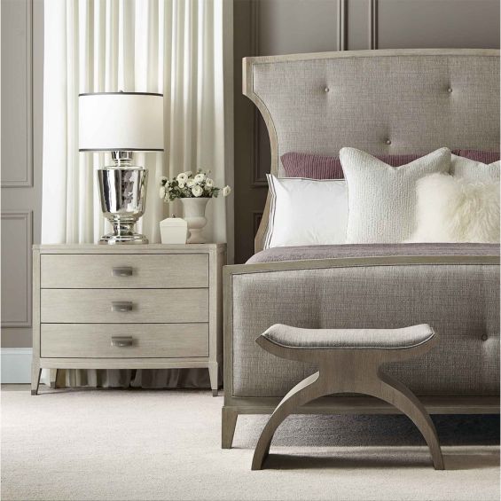 A chic minimal natural wood bedside table with tarnished nickel accents