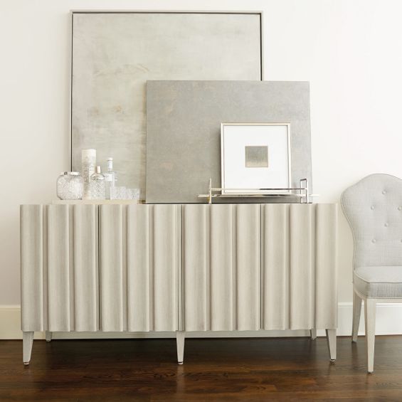 A luxurious four door entertainment unit with a natural finish, stylish shaped vertical overlays and ample internal storage 