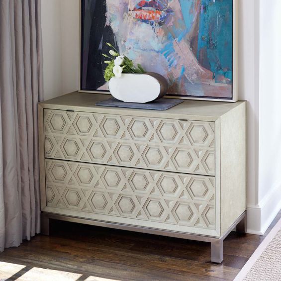 A unique two drawer chest of drawers from Bernhardt with a textured geometric design and stainless steel base with a nickel finish 