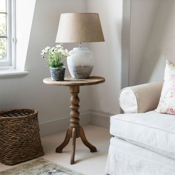 A costal, cottage-inspired table lamp with a natural linen shade