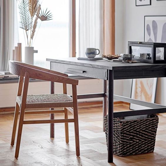 A scandi-inspired light oak chair with a braided seat