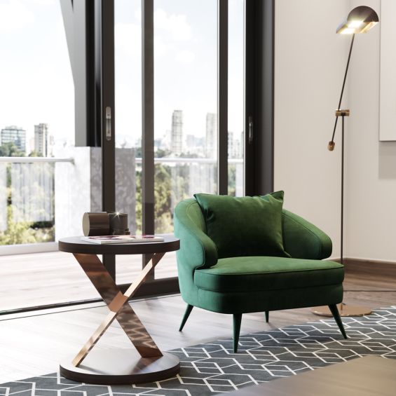 A luxurious retro-style velvet armchair with upholstered wooden legs by Laskasas. Pictured in Green.