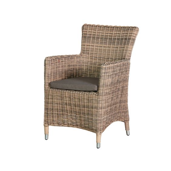 A luxury rattan outdoor dining chair with a linen upholstered seat cushion 