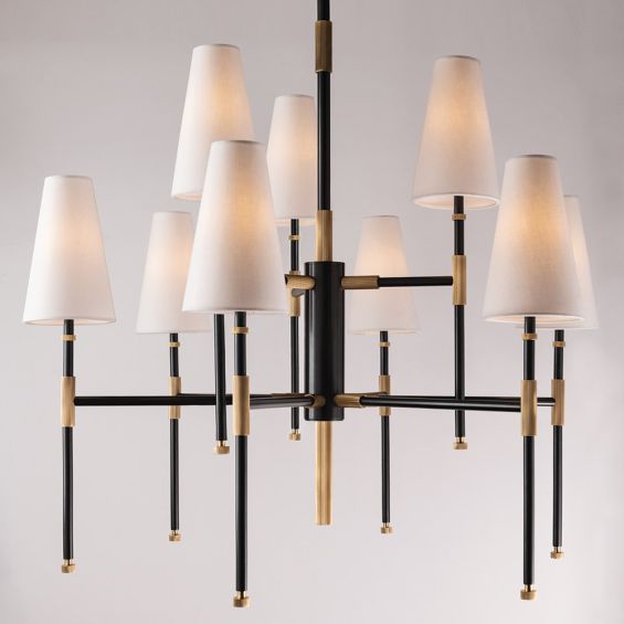 An elegant aged old bronze chandelier with multiple linen lampshades