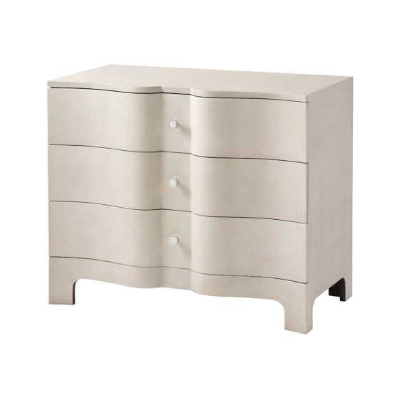 A luxurious chest of drawers with an undulating design, shagreen-embossed leather wrapping and nickel details  