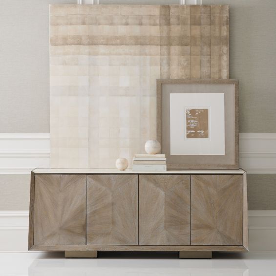 A sophisticated sideboard by Caracole with veneer patterning and a cream stone top