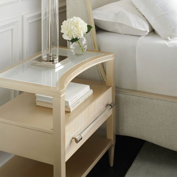 Striking and glamorous bedside table with curved surface, shelving and drawer for storage