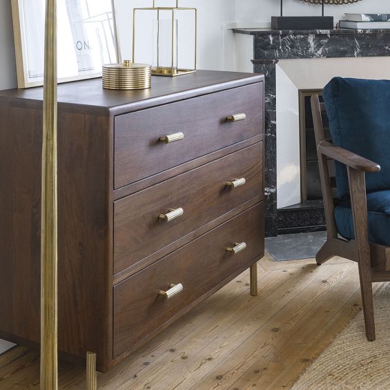 Elegant dark brown wood chest of drawers with ribbed brass handles and feet