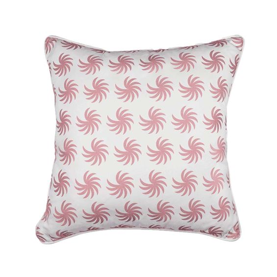 A white cushion with matching piping and a pink palm-like pattern
