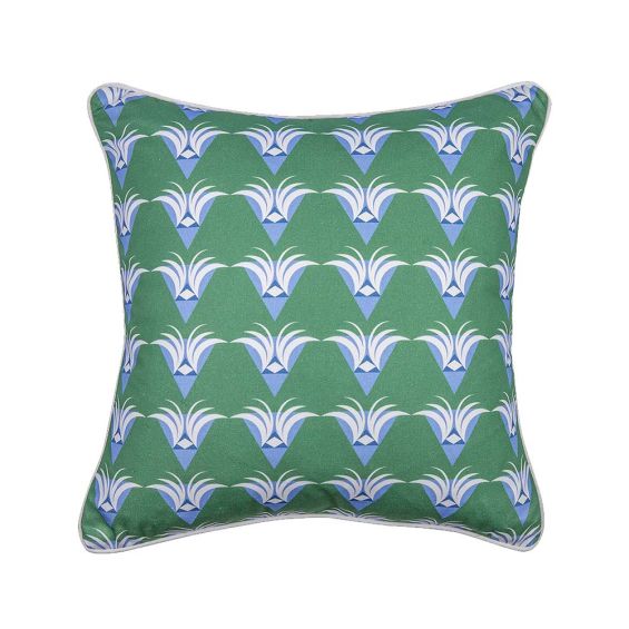 An art deco patterned cushion with blue, green and white designs and white piping