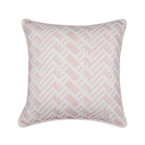 A light pink cushion with a white, lattice inspired pattern and matching white piping