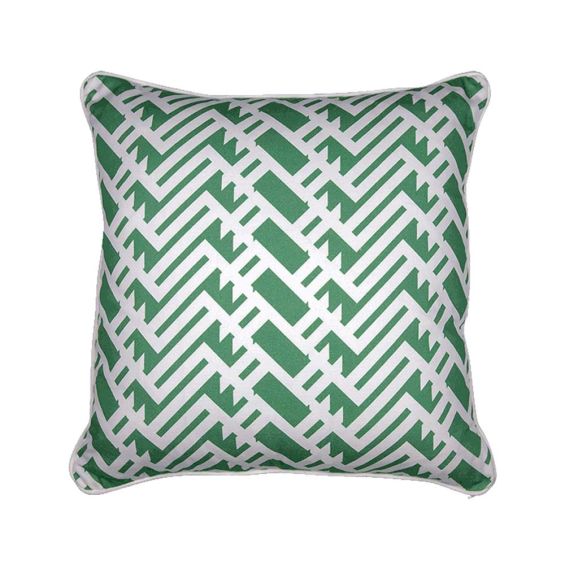 A green cushion with a lavish lattice inspired pattern and matching white piping