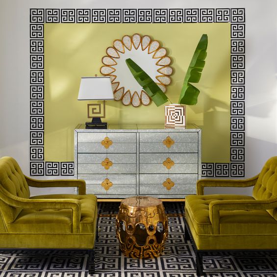 A luxurious six-drawer brass and antiqued mirror glass chest