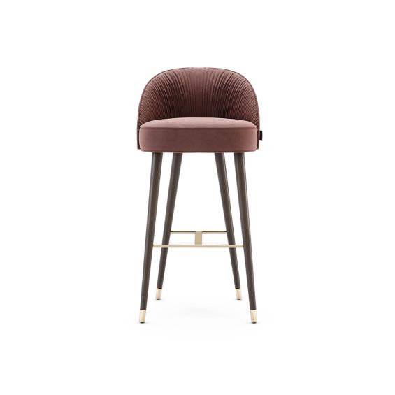 A luxurious velvet bar stool with a pleated inside back and black tapered legs with golden accents 
