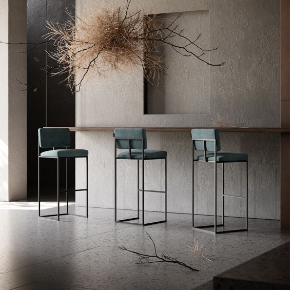 A chic, modern bar stool with a minimal black metal frame and velvet upholstery 