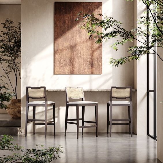 A traditional Portuguese-style counter stool with a weave upholstery and rattan back