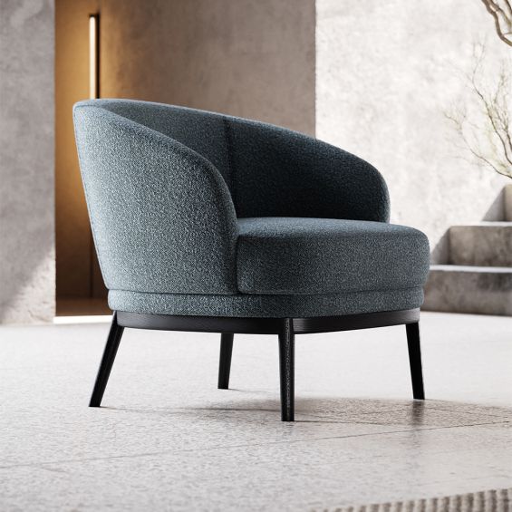 A timeless and sophisticated armchair by Domkapa with a boucle upholstery and black ash base
