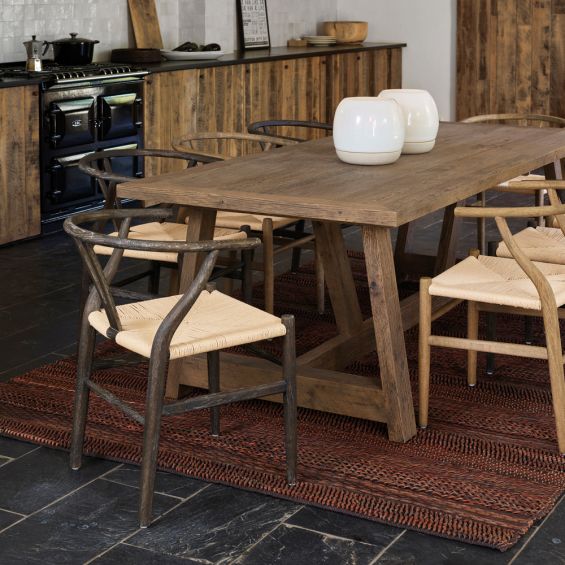 A Scandinavian-style dark brown ash wood and paper twine dining chair 
