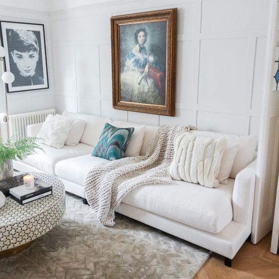A contemporary white sofa with contrasting black legs 