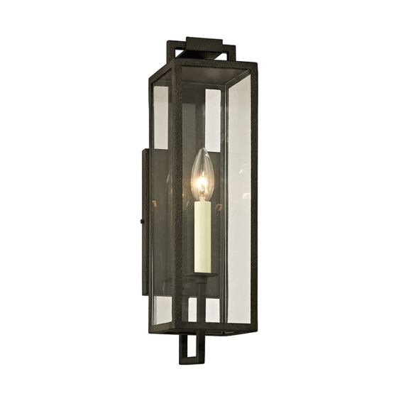 A chic black iron and clear glass wall lantern