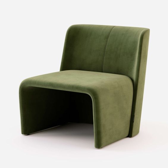 A stylishly sculptural armchair with green velvet upholstery