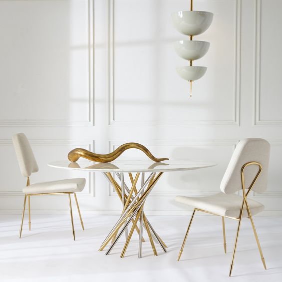 A contemporary marble table with a nickel and brass base