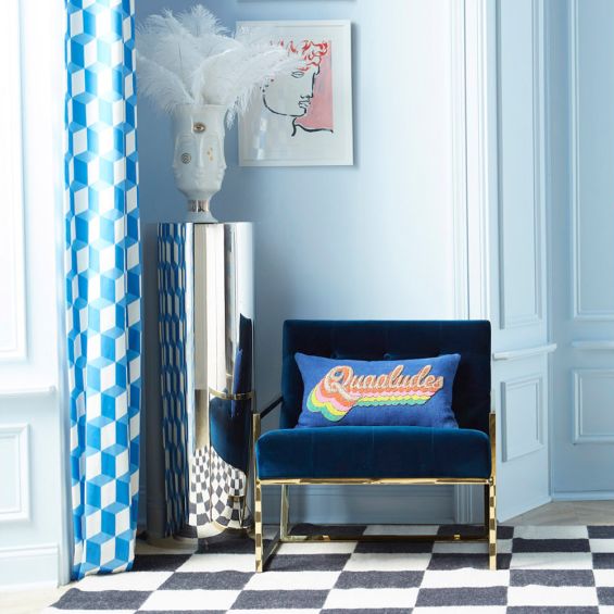 A modern navy lounge chair with a polished brass frame