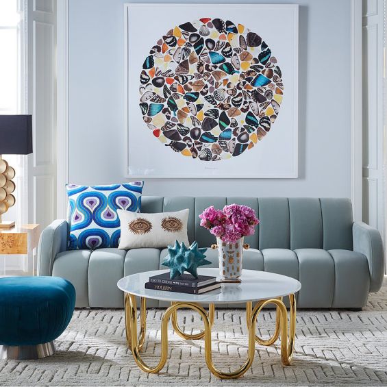 A modern sofa with grey, velvet upholstery