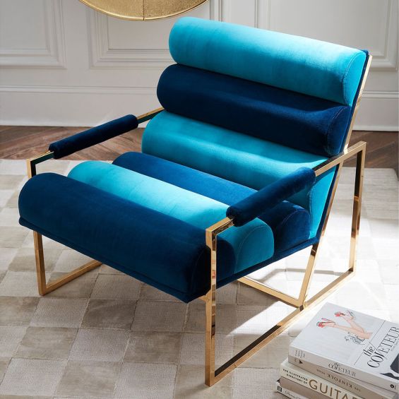 A glamorous two-toned blue velvet lounge chair 