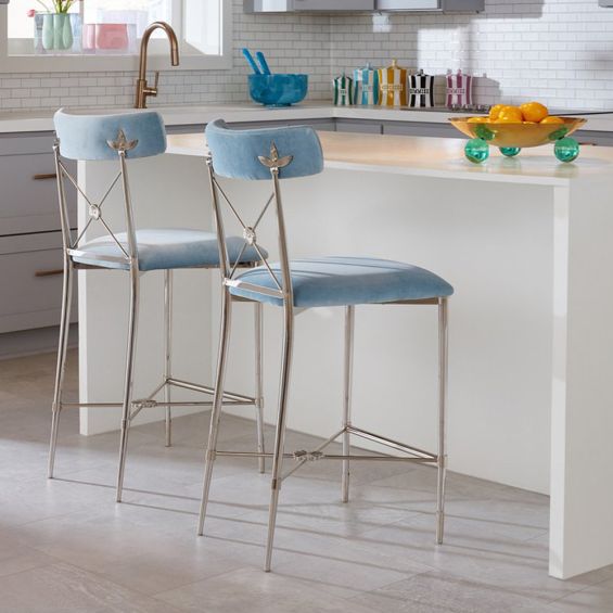 A stylish, light blue counter stool with a dazzling, silver frame 