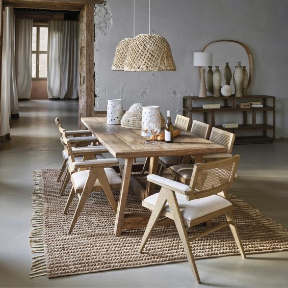 A stylish, Scandinavian-inspired upholstered armchair with a caned back rest