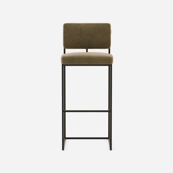 A chic, modern bar stool with a minimal black metal frame and velvet upholstery 