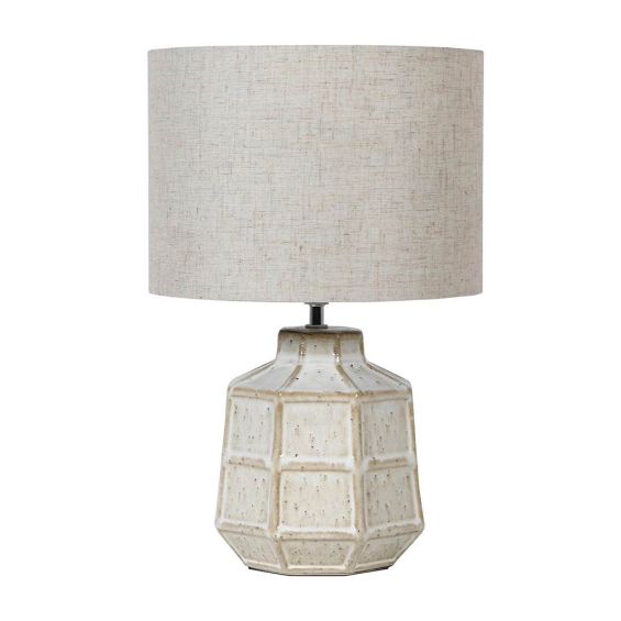 Shapely lamp with a distressed, speckled finish and linen shade