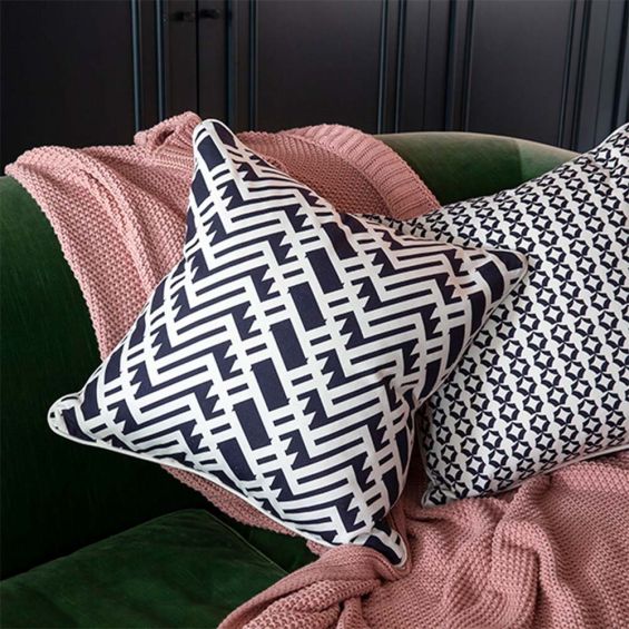 A gorgeous dark blue and white cushion with a lattice inspired design