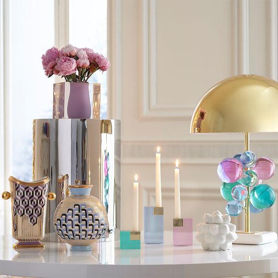 A glamorous candleholder by Jonathan Adler with a green gem toned acrylic block fitted with a solid brass candleholder