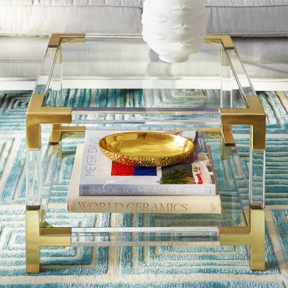A stylish brass and acrylic accent table 