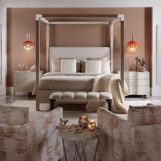 A contemporary four poster bed with a shagreen embossed leather wrapped body in a natural finish and nickel accents