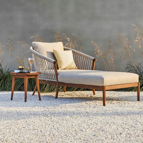 Striking outdoor chaise longue with woven rounded back and modern wooden frame